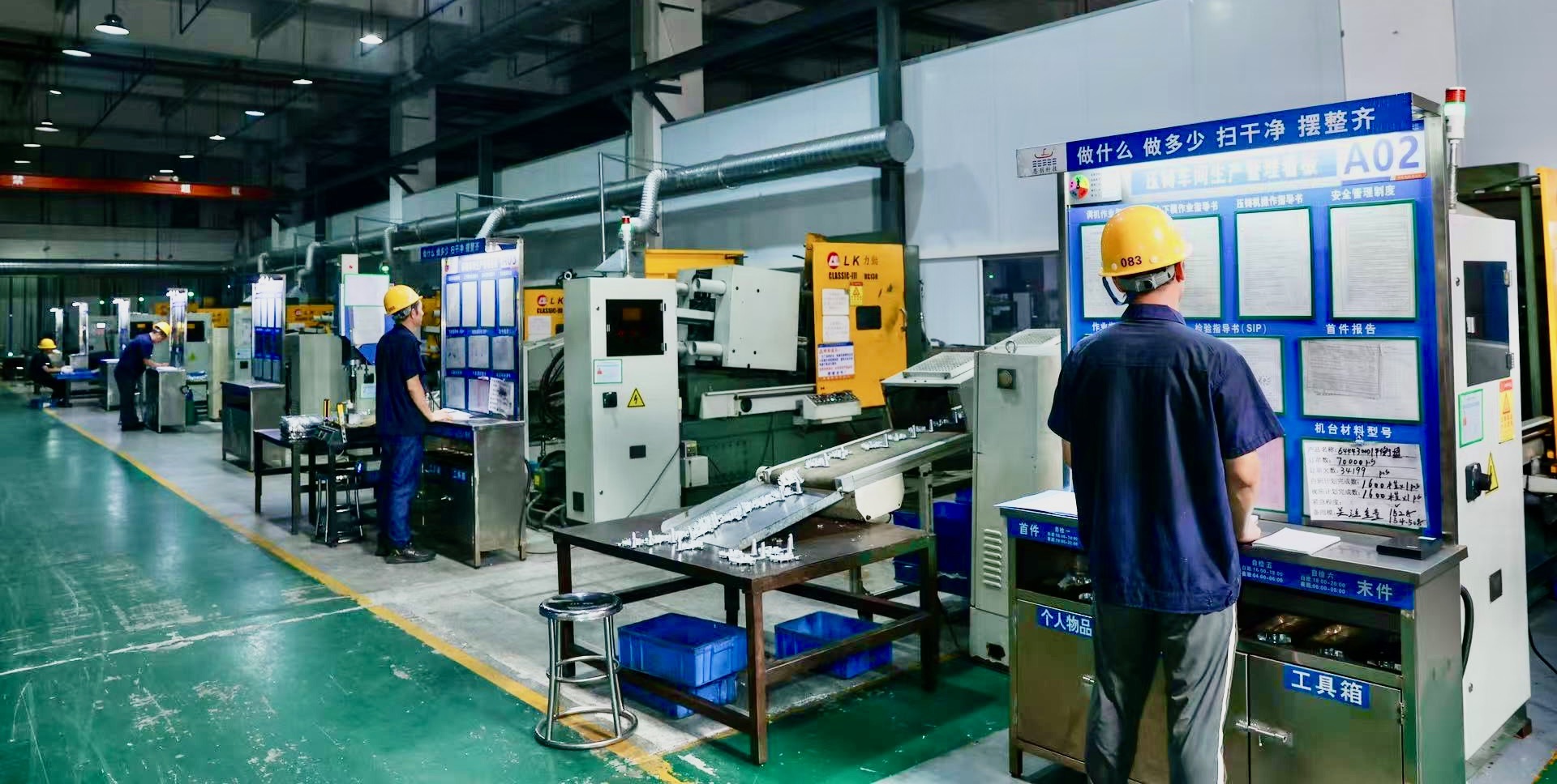 Factory floor with workers operating machinery, emphasizing teamwork and operational capability in contract manufacturing.
