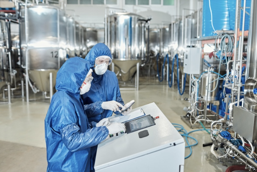 Factory workers following guidelines and safety regulations that are required for certain certifications