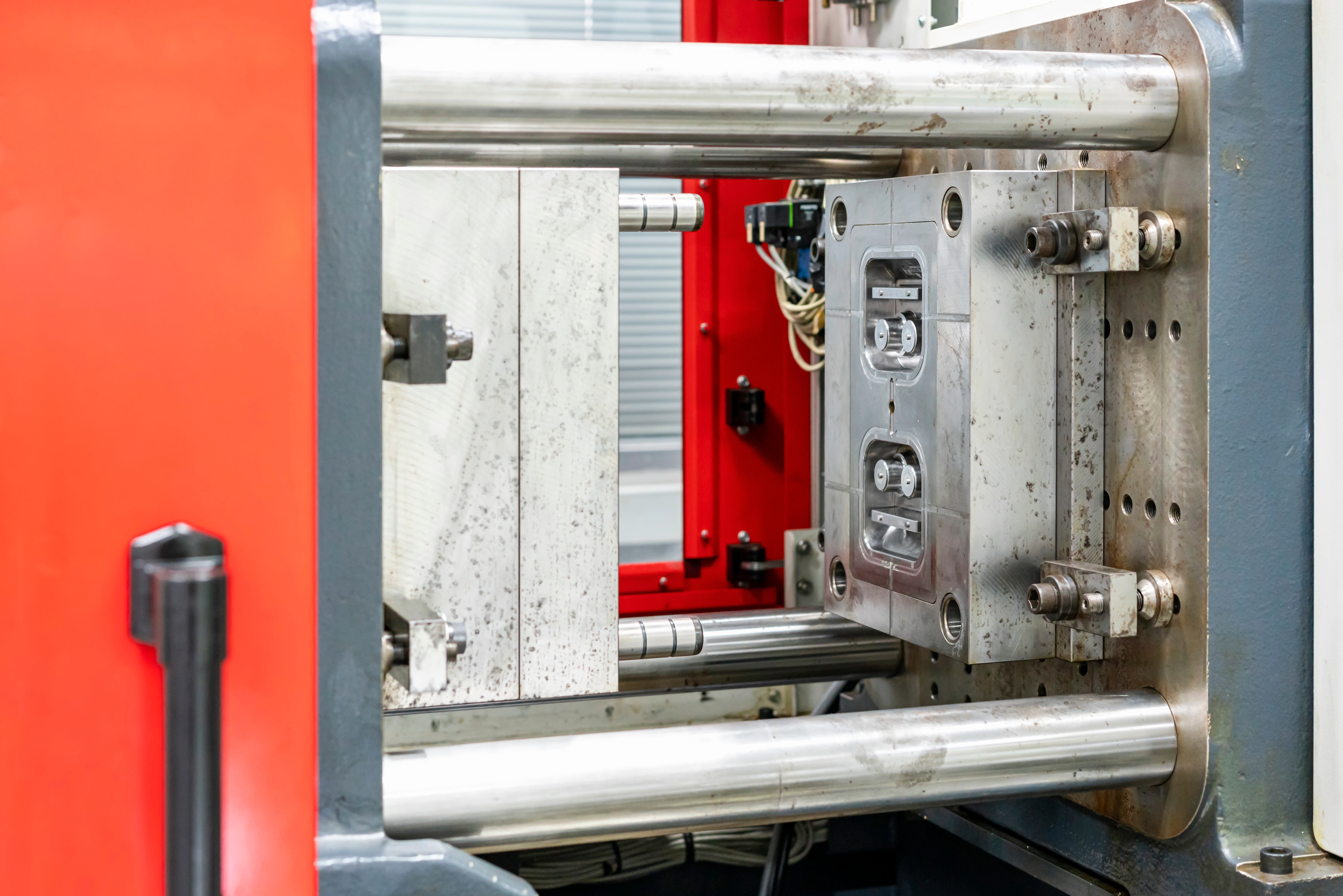 Plastic injection molding machine used to scale robotics enclosures & housings